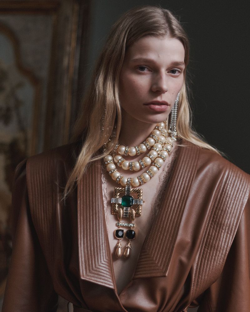 Model Saar Mansvelt Beck in a brown leather coat with a layered pearl and crystal statement necklace.