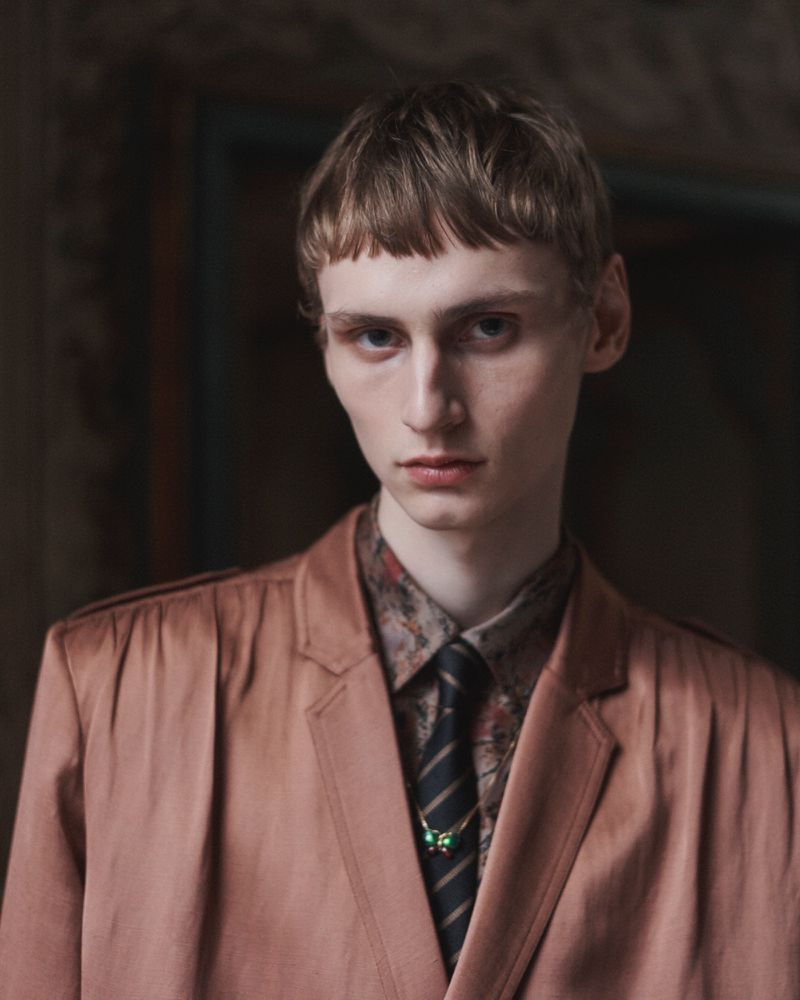 Model Saar Mansvelt Beck wearing a dusty rose tailored jacket, patterned shirt, and striped tie for Valentino.
