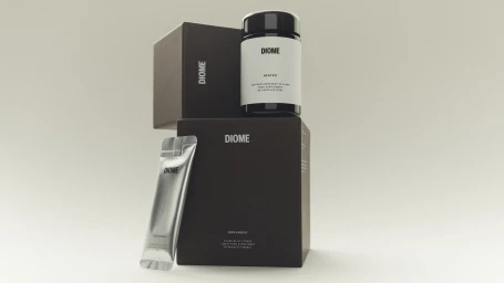 Diome supplement packaging featuring a dark capsule jar, liquid supplement sachet, and branded brown boxes on a light seamless backdrop.