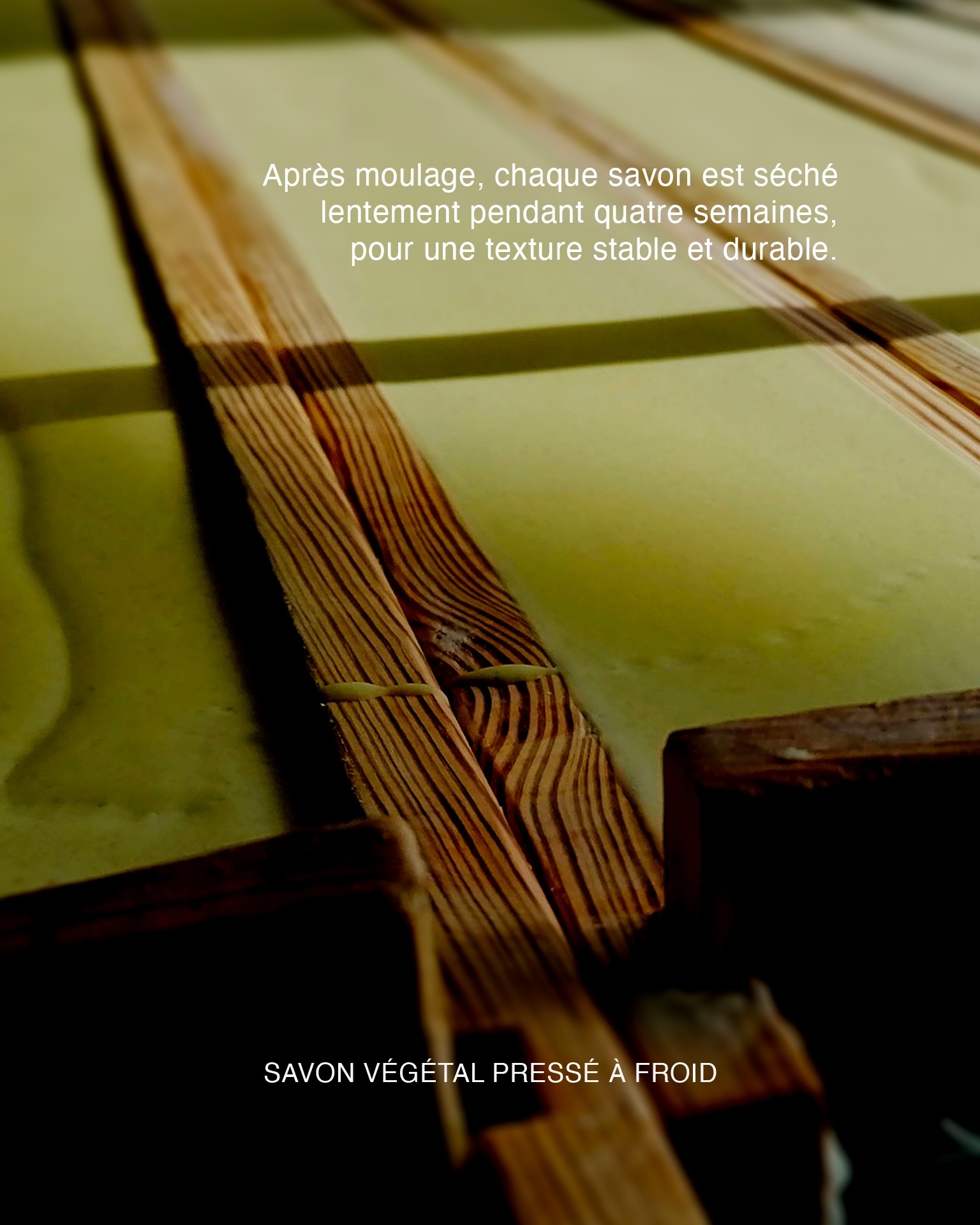 Cold-pressed artisanal soap slabs curing on slotted wooden drying racks with French descriptive text overlays.