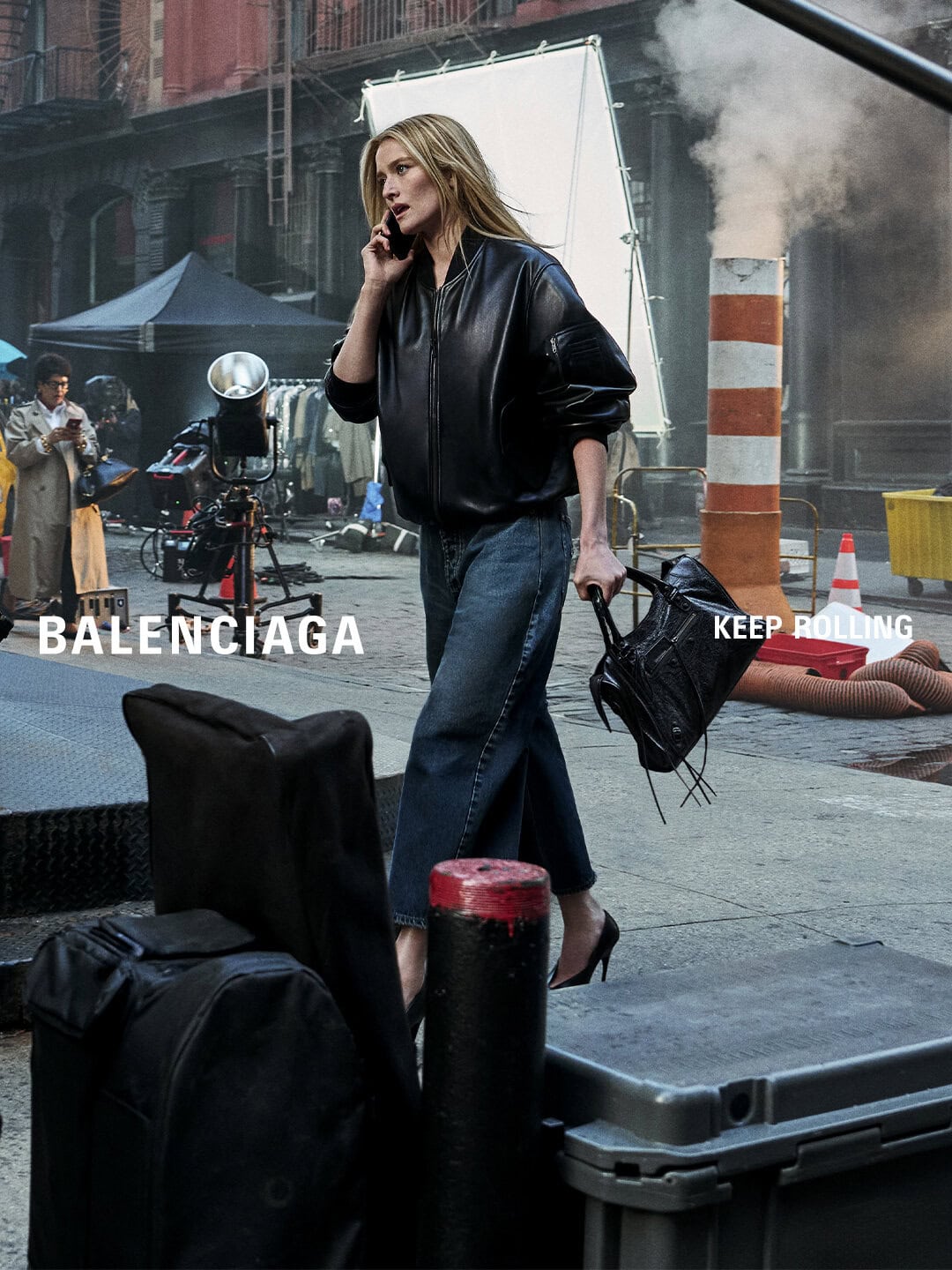 Balenciaga campaign image of Sarah Pidgeon in a black leather jacket and wide-leg jeans holding a handbag on a New York street set.