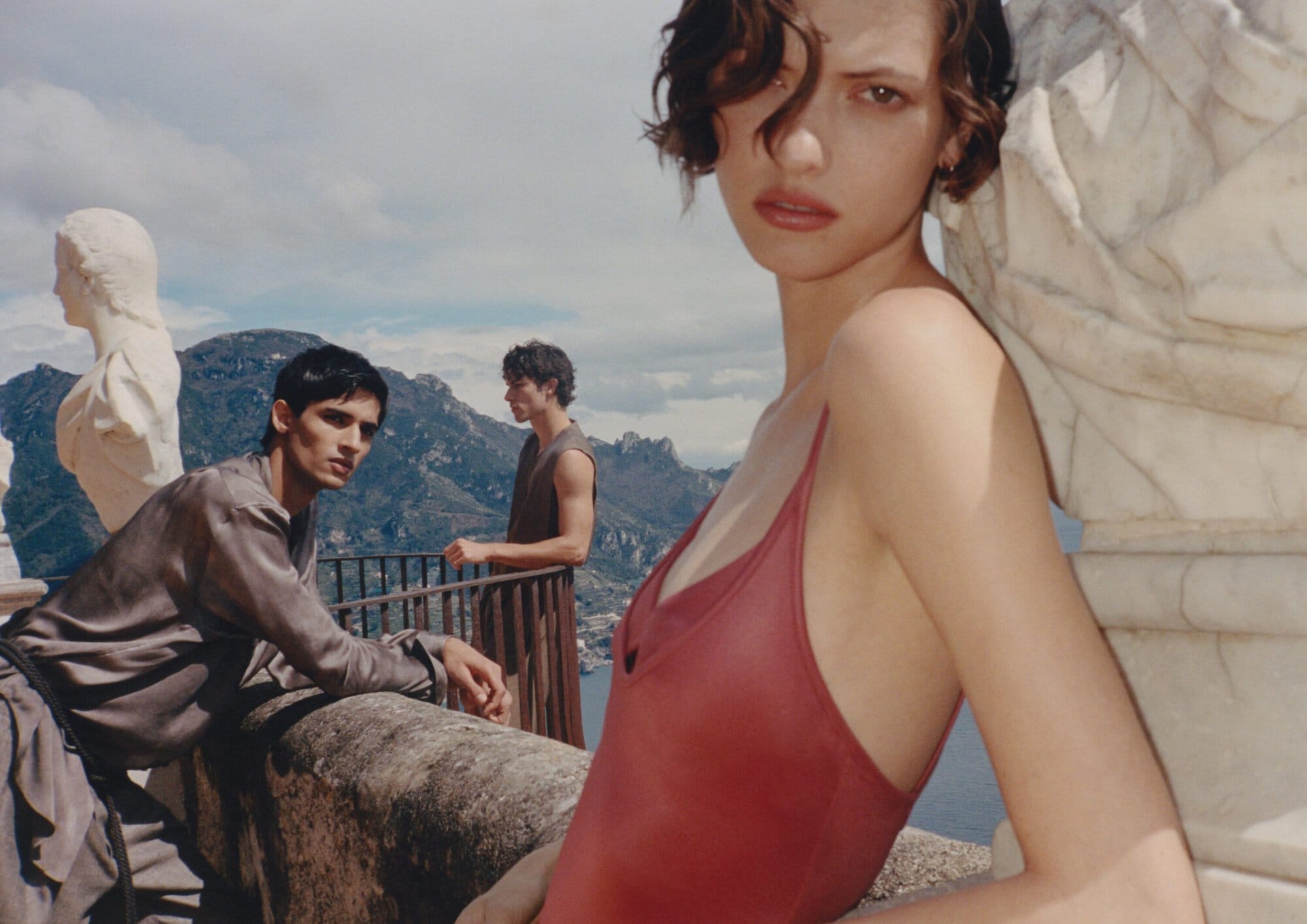 Models posing outdoors on a stone terrace overlooking mountains for the Giorgio Armani Spring 2026 campaign.