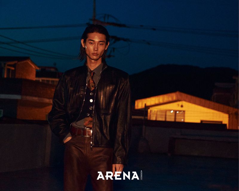 Model Taemin Park wearing a black leather jacket and tie on an urban rooftop at night for Arena Homme+ Korea.