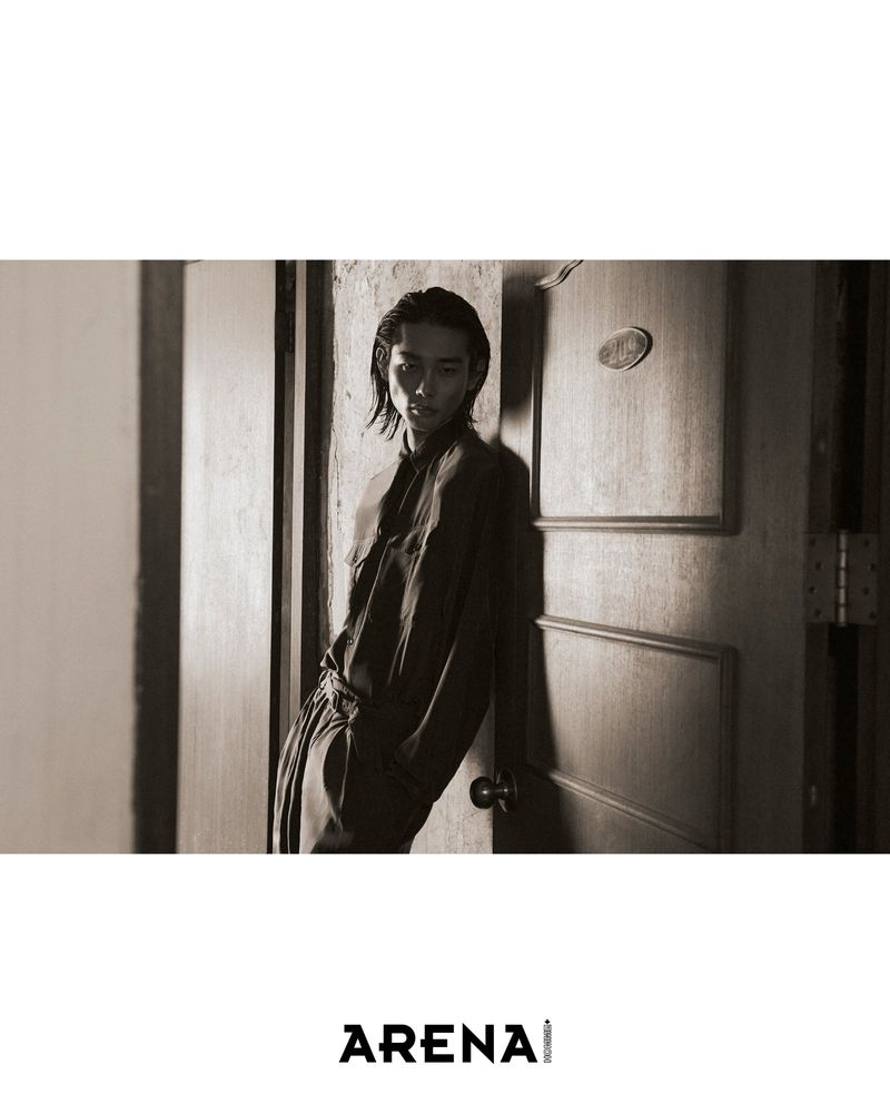Model Taemin Park leaning in a doorway for the Arena Homme Korea project titled Sticky Night