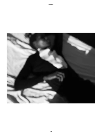 Black and white editorial portrait of a model lying on a bed with motion blur, captured by Vito Fernicola for The Travel Almanac.