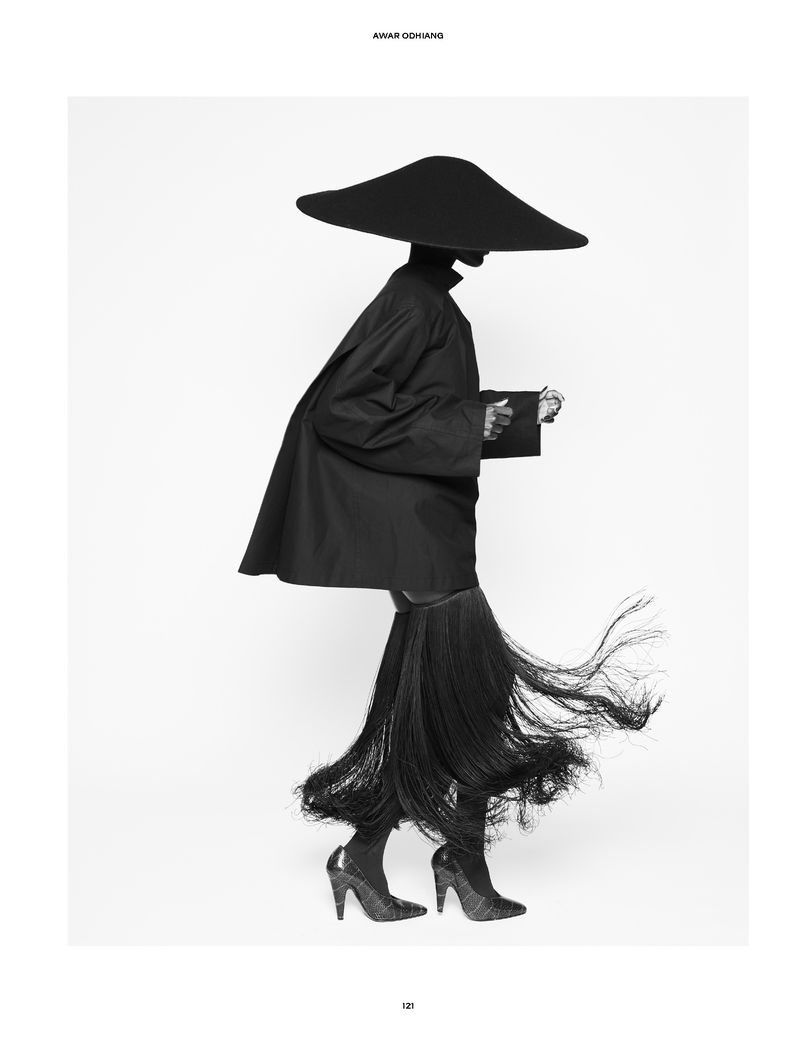 Model Awar Odhiang in a wide brim black hat and fringed skirt for The Travel Almanac photographed by Vito Fernicola