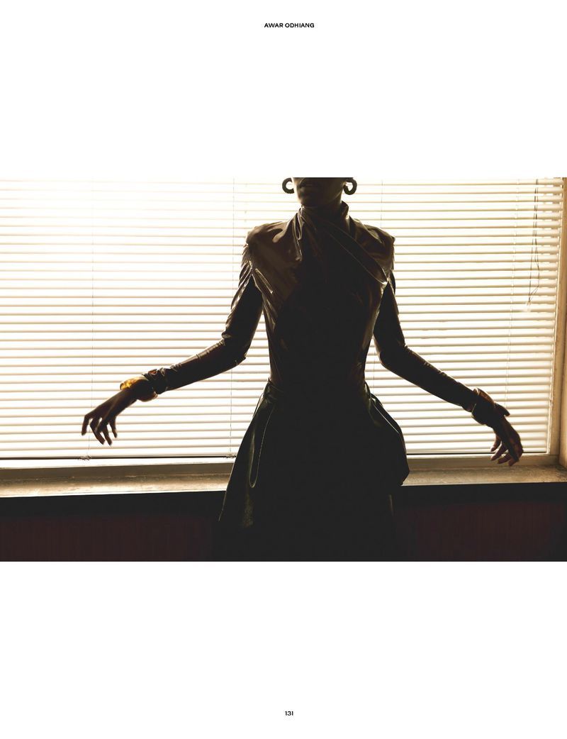 Silhouette of model Awar Odhiang posed in front of horizontal window blinds for The Travel Almanac.