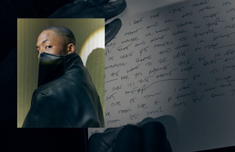 Portrait of James Massiah in a high-collar black leather jacket overlaid on a sheet of handwritten text held by gloved hands.