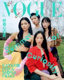 Four models posing outdoors in colorful editorial styling in front of a Ferris wheel for a Vogue Japan magazine cover.
