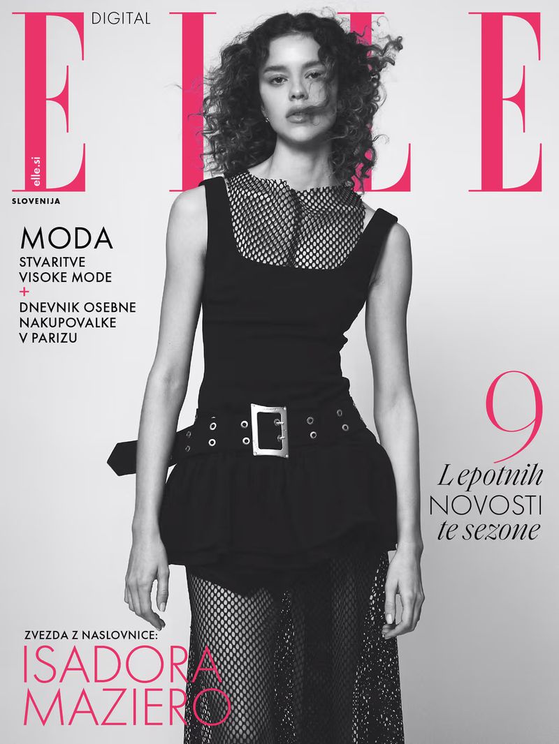 Elle Slovenia magazine cover featuring a slender female fashion model wearing a dark top and mesh skirt, posing in a photo studio.