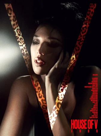 Close-up portrait of an East Asian woman framed by a large leopard-print V graphic against a dark background.