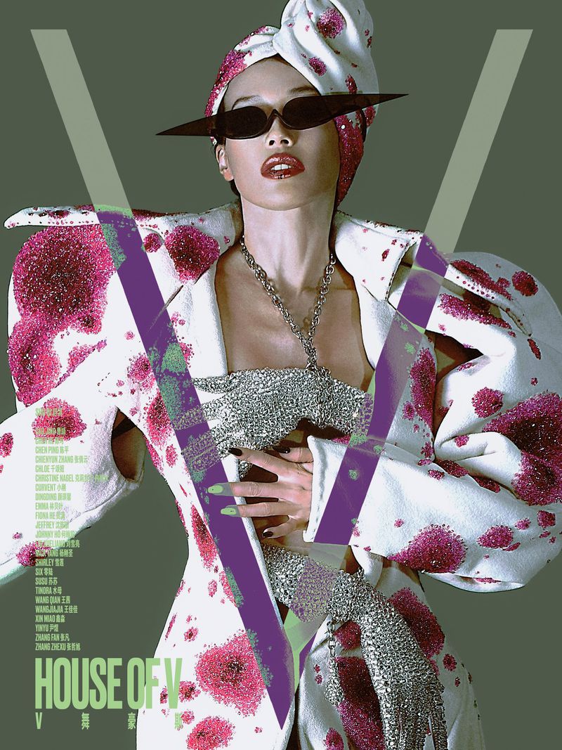 Model wearing an avant-garde white and pink spotted coat and angular sunglasses on a magazine cover.