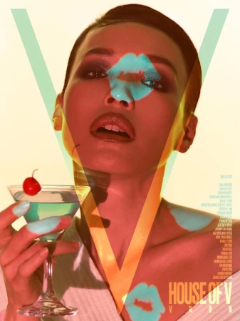 Actress Shu Qi poses with a cocktail in a martini glass under warm lighting and cyan graphic projections for V Magazine China.