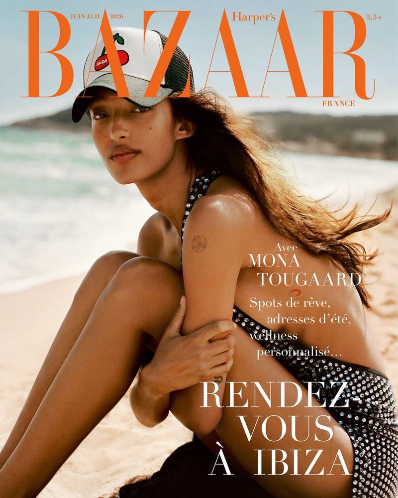 Harper's Bazaar cover featuring a model on a beach with a baseball cap, posing in a black polka dot dress with a sandy background.