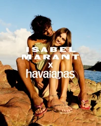 Marlon Teixeira and Mia Armstrong sitting together on coastal rocks wearing flip-flops for Isabel Marant x Havaianas.