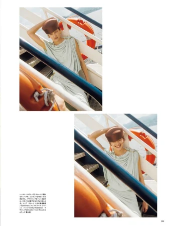 Model in light green dress and brown pillbox hat posing on a ferry stairwell for Numero Tokyo