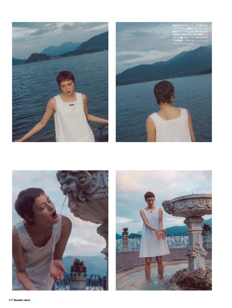 Outdoor fashion shoot featuring a young woman in a white dress near a fountain and lake, creating a serene and elegant visual narrative.