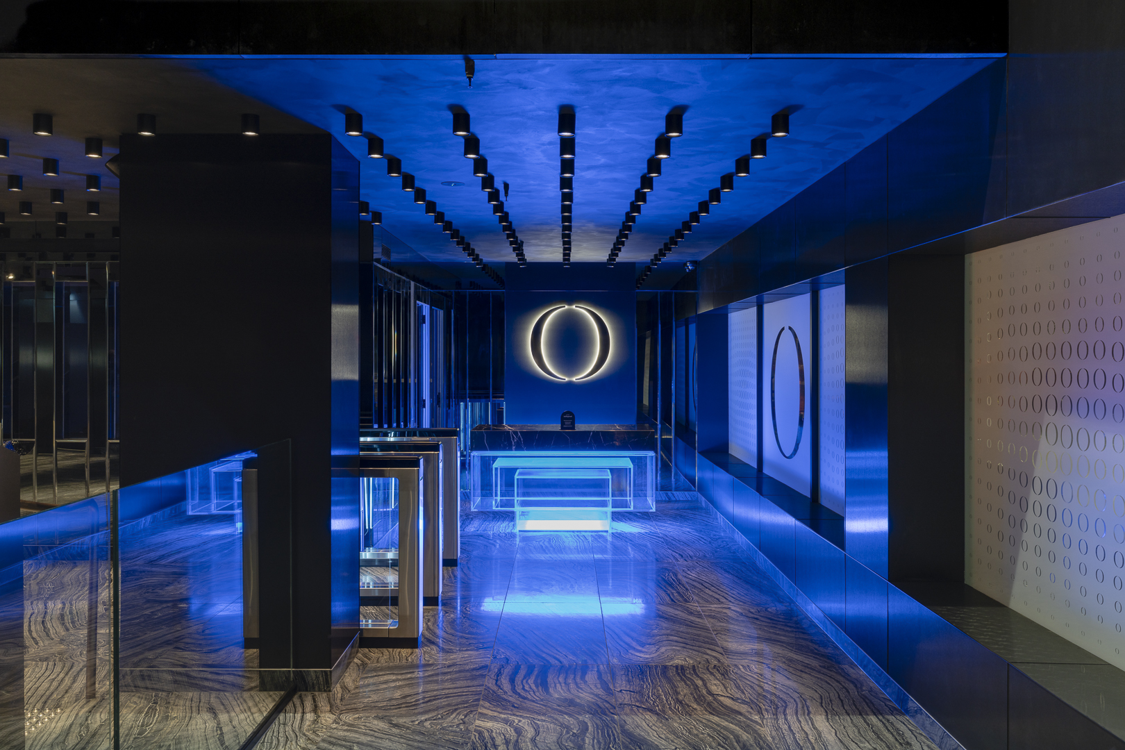 Interior space featuring neon lighting and illuminated surfaces, complemented by polished floors and modern architectural design.