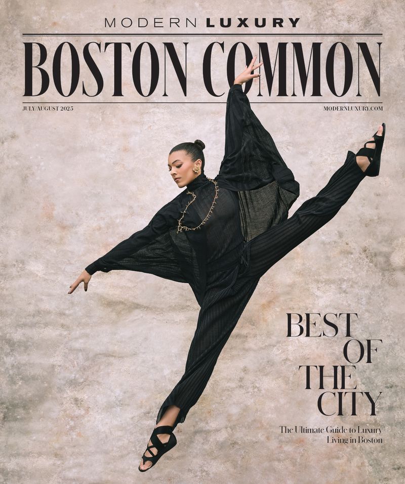 Magazine cover featuring a Black female dancer in a split leap wearing a black jumpsuit and gladiator sandals against a textured background.