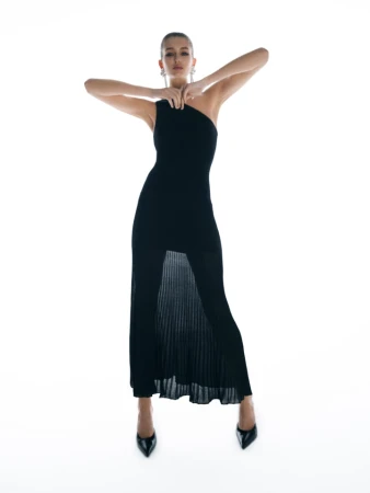Model in a black one-shoulder maxi dress wearing heels against a plain white background for Witchery