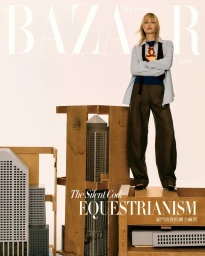 Singer Angèle posing with crossed arms over architectural models and wooden crates for Harper's Bazaar Taiwan.