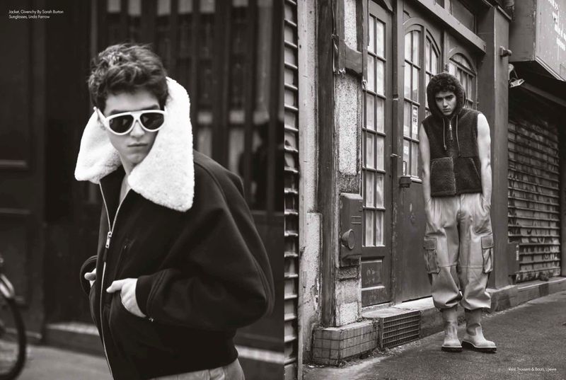Black and white street editorial featuring a man in white sunglasses and a fleece-collar jacket alongside another in cargo pants.