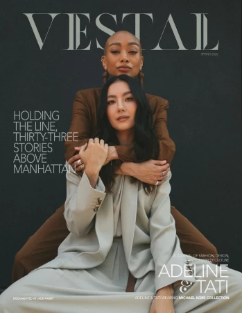 Vestal Magazine cover featuring Adeline and Tati embracing in tailored beige and brown suits against a black studio backdrop.