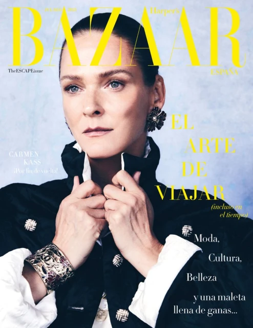 Magazine cover featuring Carmen Kass in black jacket with statement jewelry against a light blue textured background with text overlays.