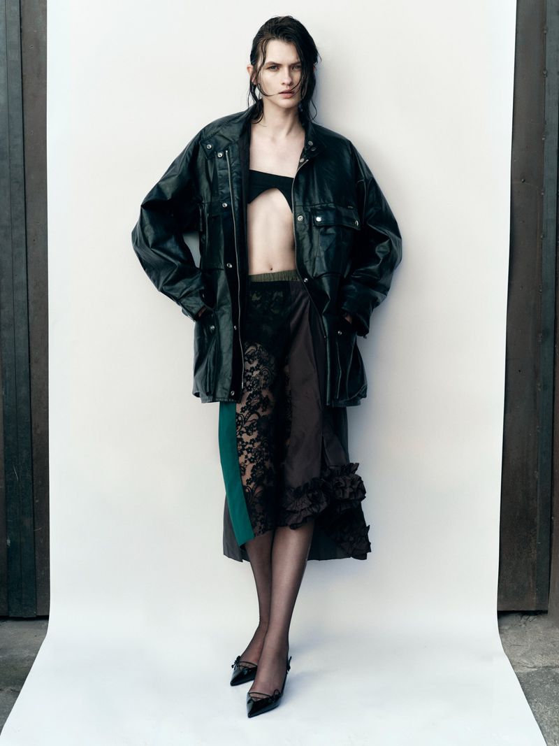 Model in black leather jacket and lace skirt against a white studio background shot by Javier Biosca for Telva.