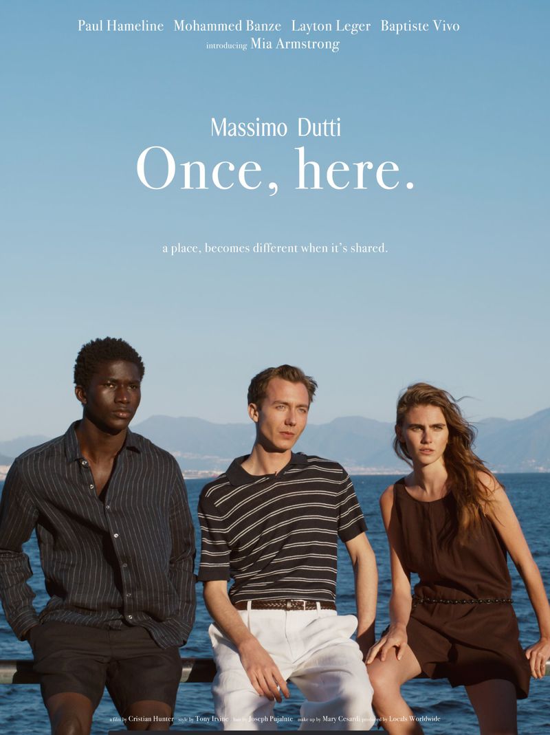 Three models in summer clothing posed outdoors by the sea against a clear blue sky for Massimo Dutti.