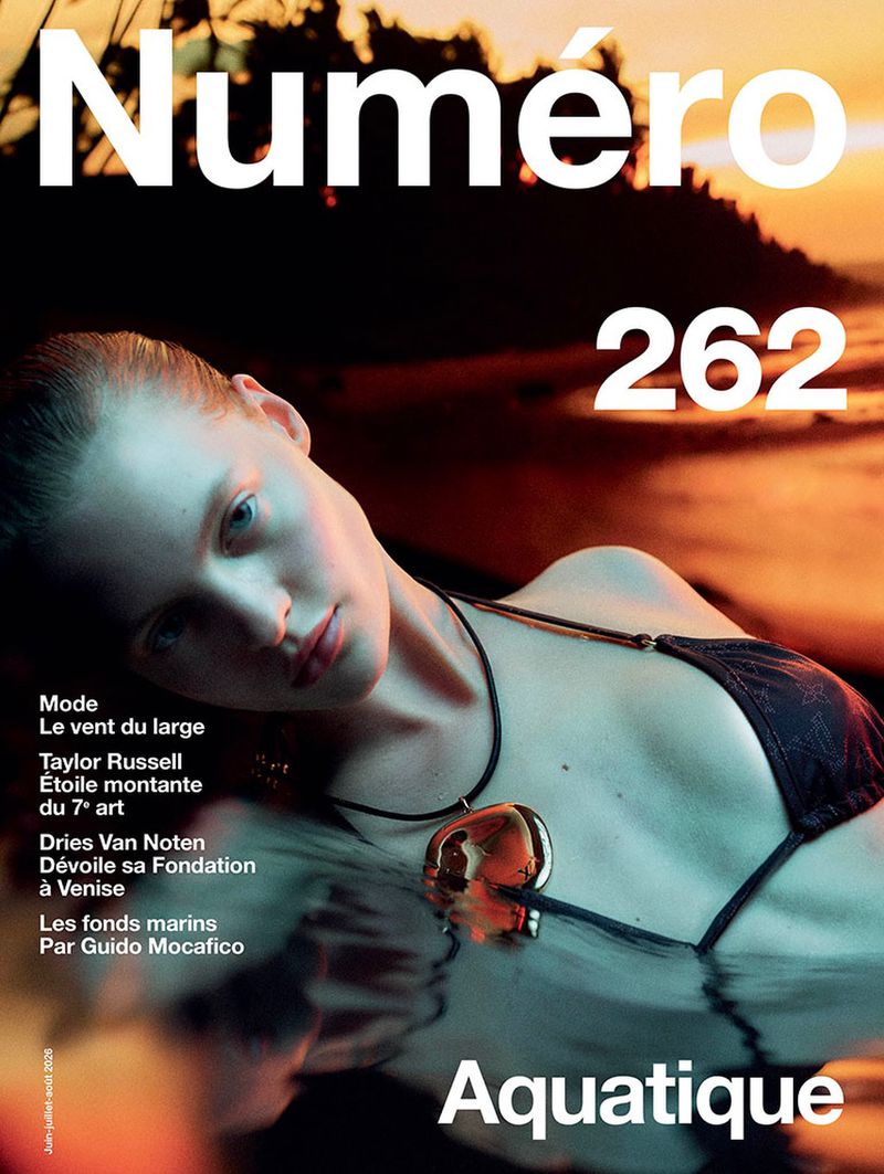 Model wearing a black bikini and metallic pendant floating in water at sunset on the cover of Numéro magazine issue 262.