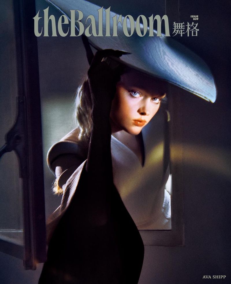 The Ballroom magazine cover featuring a blonde woman with blue eyes, wearing a wide-brimmed hat and gloves, in dramatic lighting.