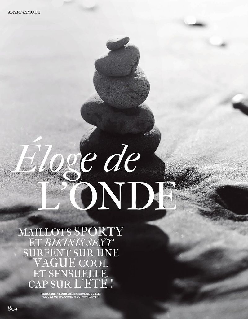 Black and white editorial layout featuring a vertical stack of balanced stones on sand with typography reading Éloge de L'onde.