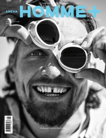 Black and white magazine cover featuring Oleksandr Usyk smiling and holding vintage goggles over his eye for Arena Homme+.