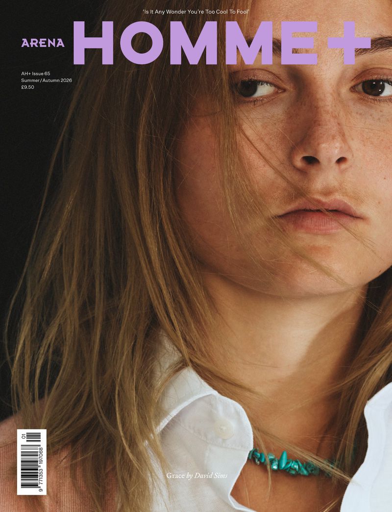 Close-up portrait of a model with light brown hair and freckles on the Arena Homme+ magazine cover.