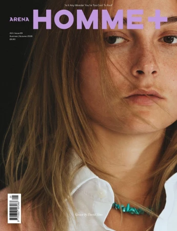 Close-up portrait of a model with light brown hair and freckles on the Arena Homme+ magazine cover.