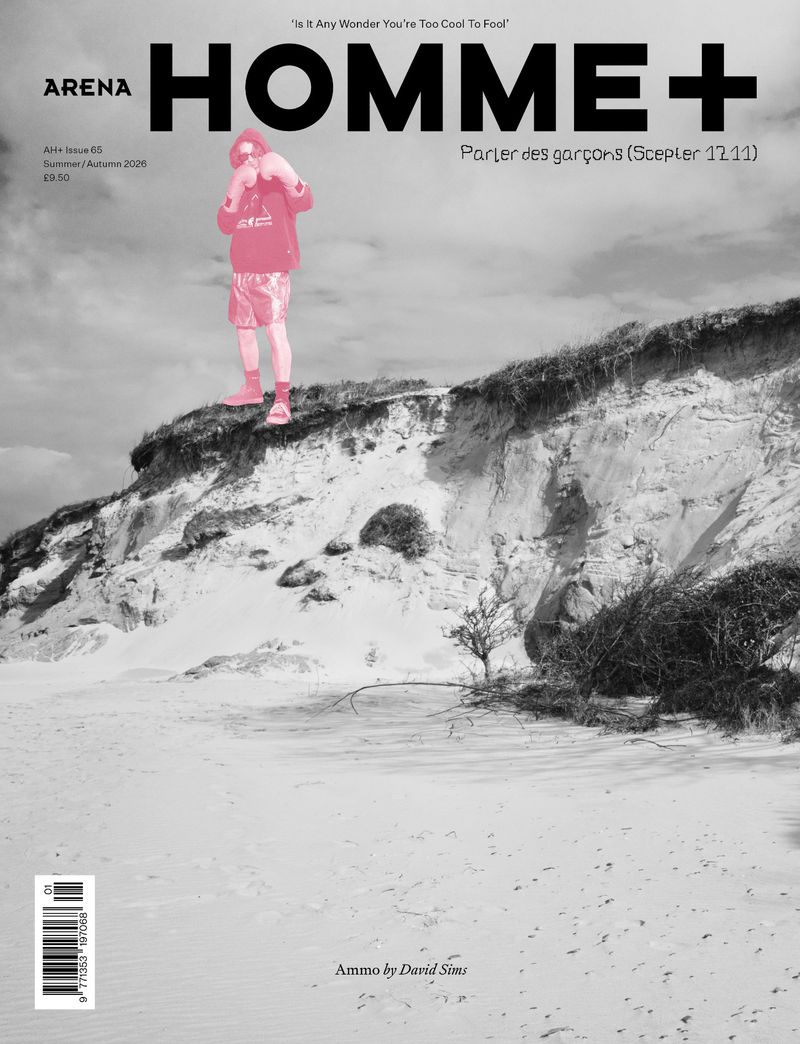 Arena Homme+ magazine cover featuring a bright pink silhouette figure atop a black and white coastal sand dune cliff.