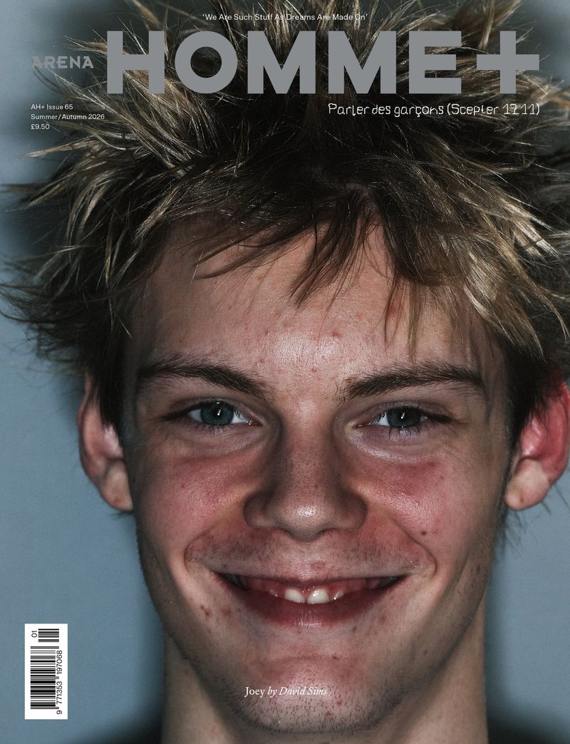 Close-up portrait of a smiling young man with spiky hair on the cover of Arena Homme+ magazine.