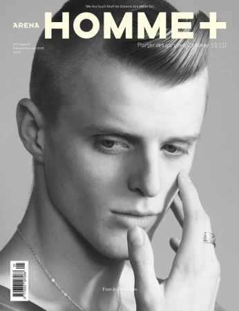 Black and white portrait of Finn Collins with styled hair touching his cheek for the cover of Arena Homme+ magazine.