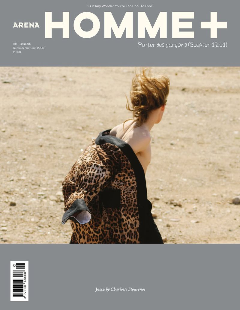 Arena Homme+ magazine cover featuring model Jesse shirtless wearing a draped leopard print jacket in a dry sandy landscape.