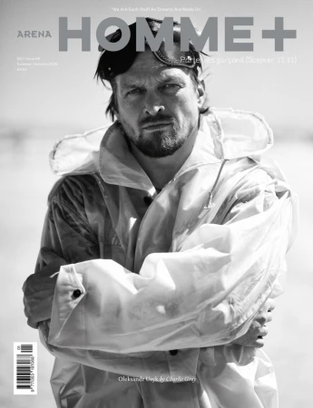 Black and white magazine cover featuring boxer Oleksandr Usyk in a hooded jacket and goggles on his head with arms crossed.