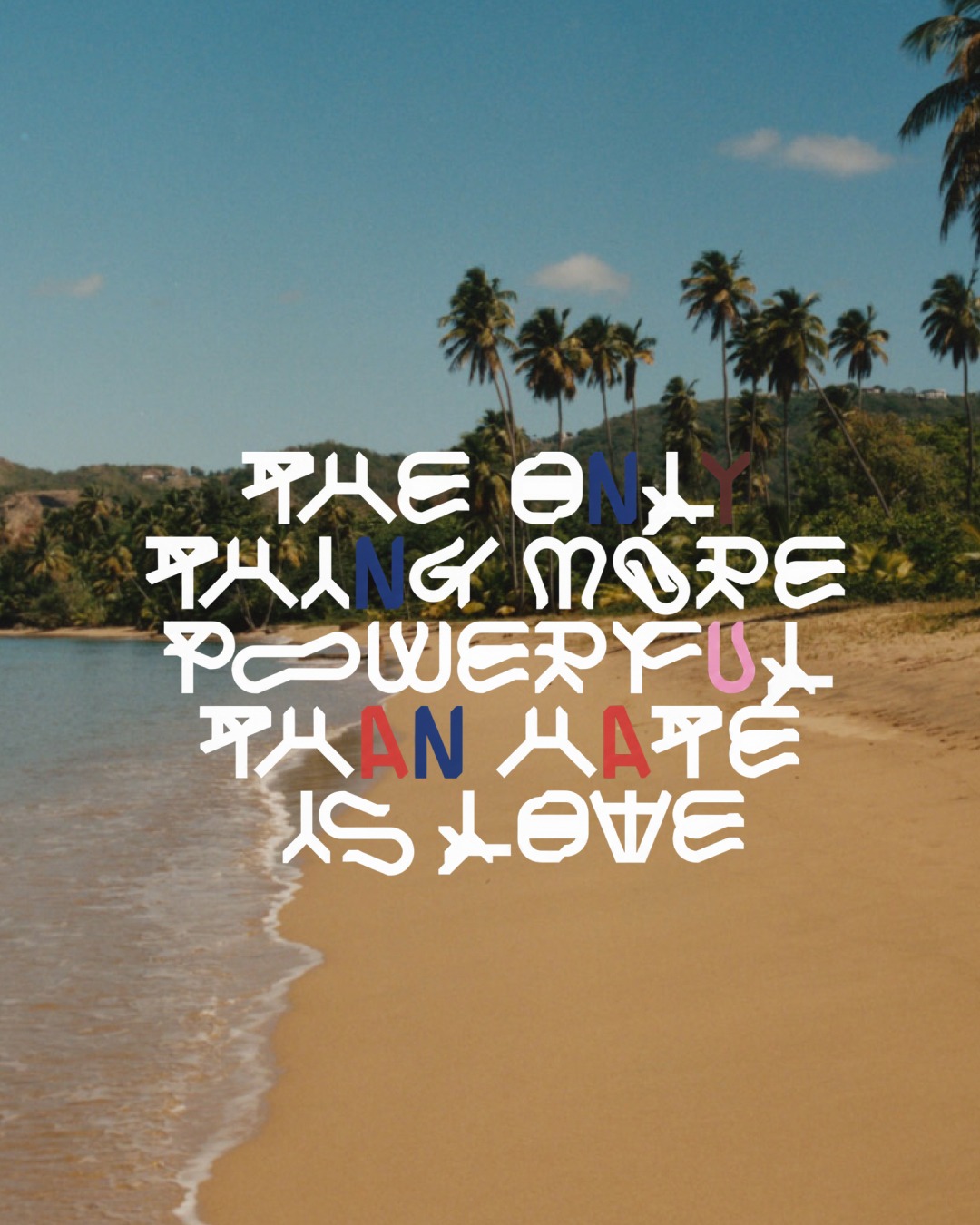 Stylized white typography reading 'THE ONLY THING MORE POWERFUL THAN HATE IS LOVE' centered over a tropical sandy beach with palm trees.