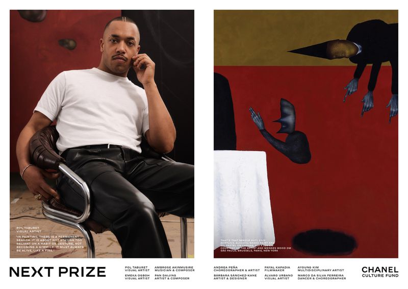 Visual artist Pol Tabouret in a white t-shirt and black leather pants seated next to his red figurative painting.
