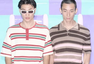 Two male models in retro striped short-sleeve shirts and white sunglasses against a pastel paneled backdrop.