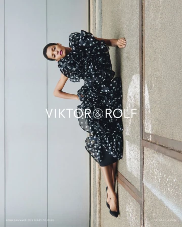 Model Laiza de Moura reclines in a black and white polka dot ruffled dress for the Viktor & Rolf Spring/Summer 2026 campaign.