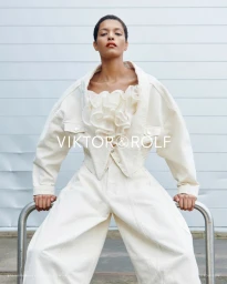 Model Laiza de Moura wearing an off-white ruffled top and matching denim jacket and wide-leg trousers for Viktor and Rolf.