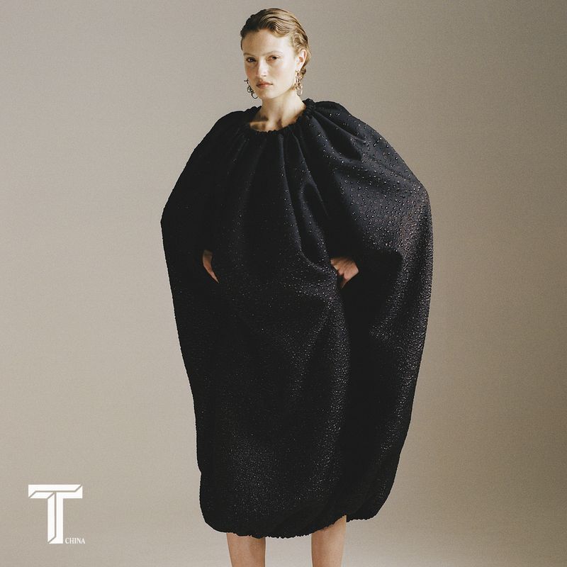 Tess Grootjen wearing an oversized black sculptural cocoon dress against a studio backdrop for T Magazine China.