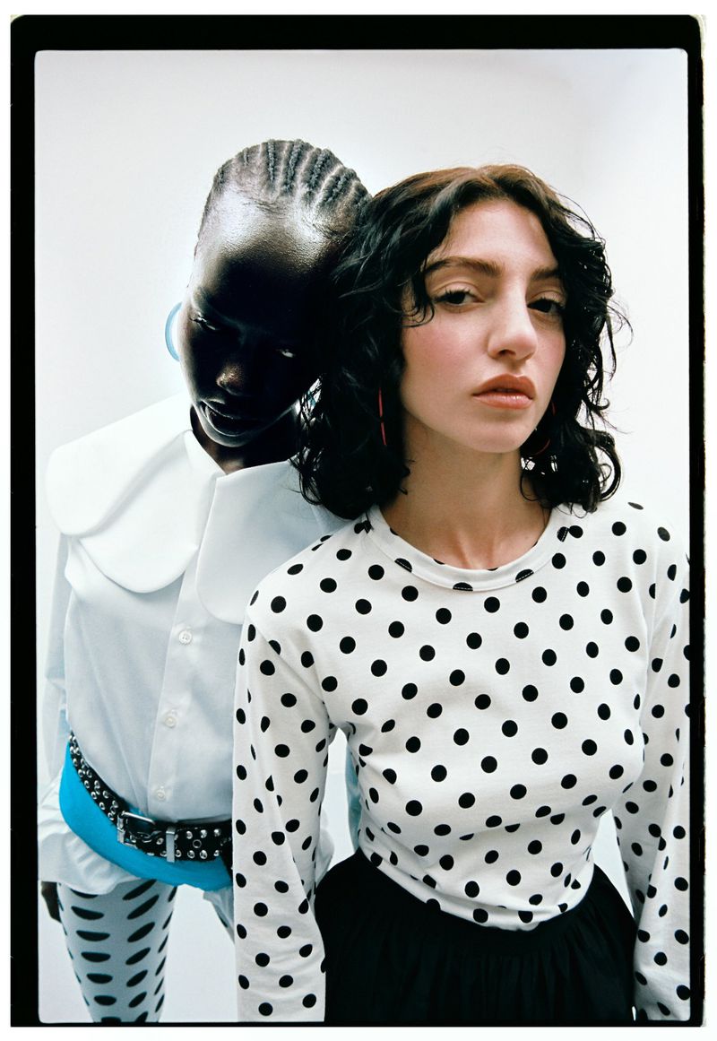 Two fashion models posing closely together against a white background for the editorial project Mirror Tension by Schön Magazine.