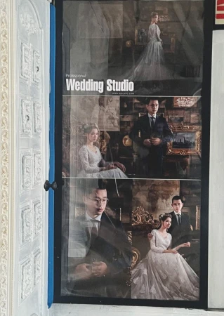Collage of wedding portraits in a photo studio display with an ornate door on the left, showcasing couples in formal attire and elegant settings.