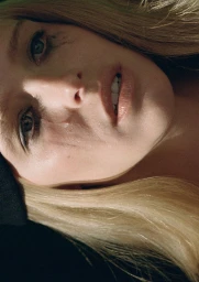Close-up portrait of model Abby Champion with blonde hair and dark eye makeup shot for ALL-IN 08 by Tanya and Zhenya Posternak.